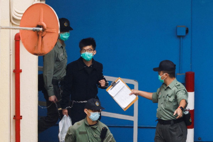 Pro-democracy activist Joshua Wong walks to a prison van to head to court with other activists, over a national security law charge, in Hong Kong, China March 4, 2021.
