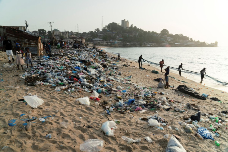 Fishermen pull in a net on the trash strewn beach in West Point, one of the poorest and most densely populated communities in Monrovia, Liberia March 7, 2022. Picture taken March 7, 2022.