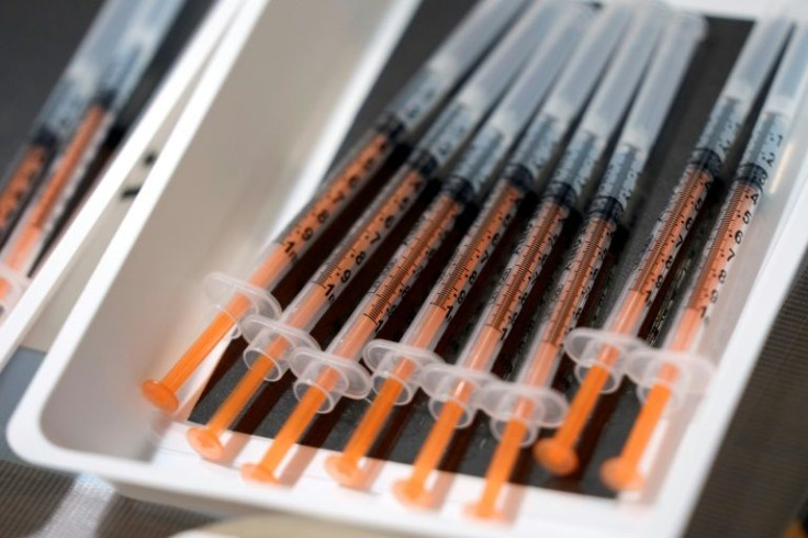 Vials of the Moderna COVID-19 vaccine against Covid-19, are being prepared for local residents in a tray at a mass vaccination center operated by Japanese Self-Defense Force in Tokyo