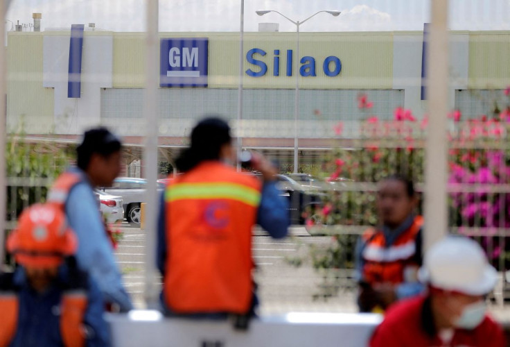 Workers sit outside the General Motors plant as its employees are to vote on whether to reject or keep the collective bargaining agreement, marking the first major test of labor rules under the United States-Mexico-Canada Agreement (USMCA), in Silao, Mexi
