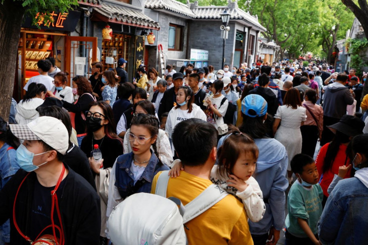 People walk along Nanluoguxiang alley during the Labour Day holiday, following the outbreak of the coronavirus disease (COVID-19), in Beijing, China May 4, 2021. 