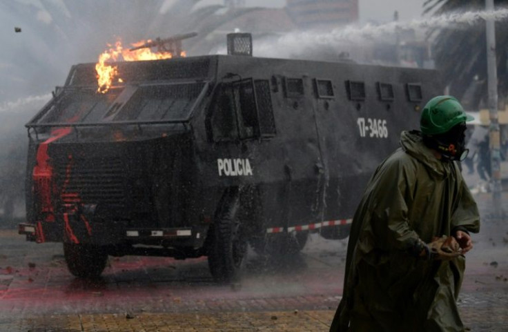 Riot police are seen during a protest against the government of Colombian President Ivan Duque outside Nacional University in Bogota, on April 28, 2022