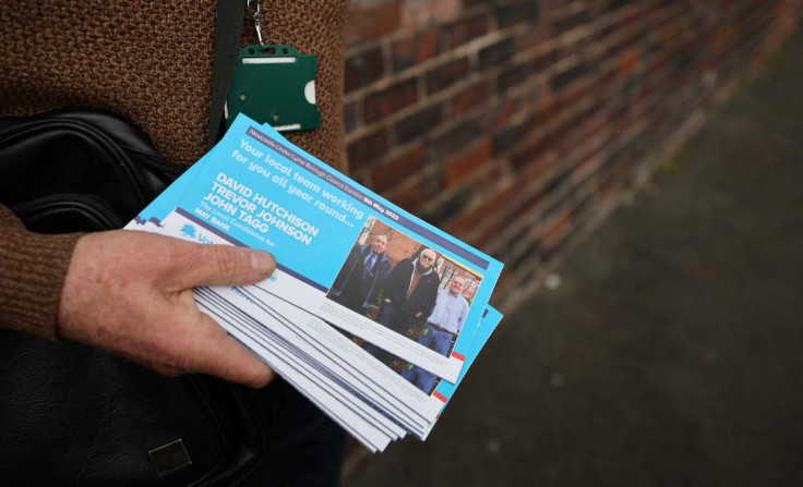 Conservative Party Councillor Trevor Johnson delivers election leaflets to houses in Newcastle-under-Lyme, Britain, April 26, 2022. Picture taken April 26, 2022. 