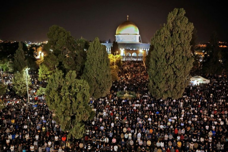 Palestinians pray outside the Dome of the Rock in Jerusalem's Al-Aqsa mosque compound on Laylat al-Qadr, the night on which according to tradition the holy Koran was revealed to the Prophet Mohammed