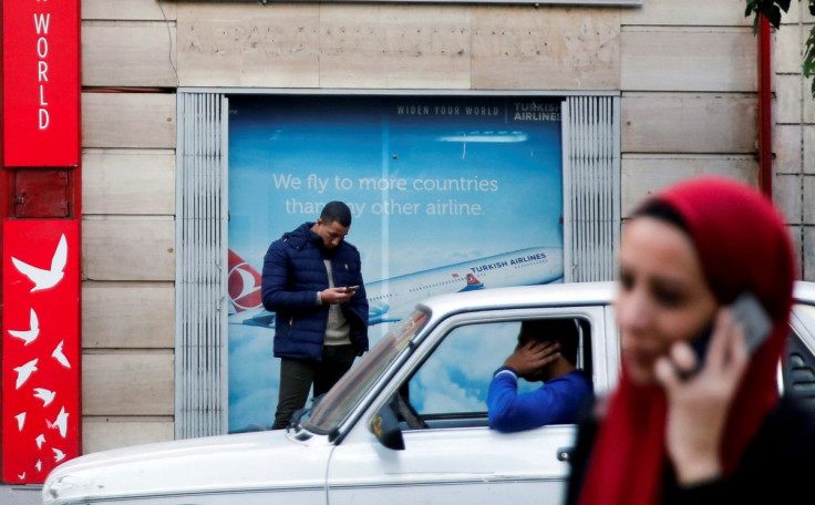 People use their mobile phones in front of the office of Turkish airlines in Cairo, Egypt December 24, 2017. Picture taken December 24, 2017.