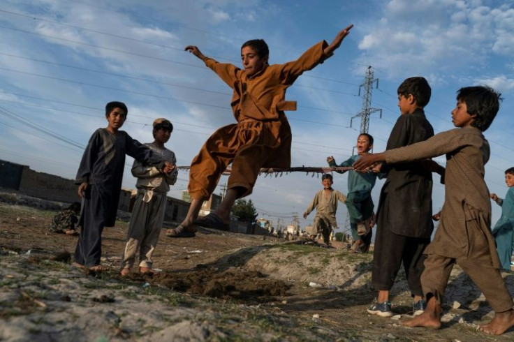 Afghan children play in a field in Kabul ahead of the end of Ramadan