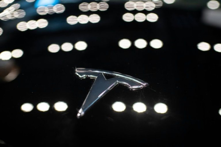 A Tesla logo is seen on a car at a dealership in Beijing