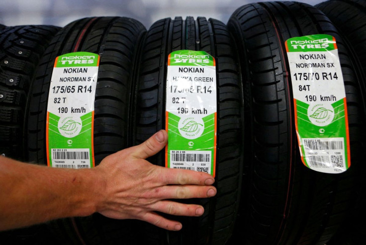An employee sorts Nokian tyres at a tyre assembling centre and shop in Moscow, August 8, 2014.