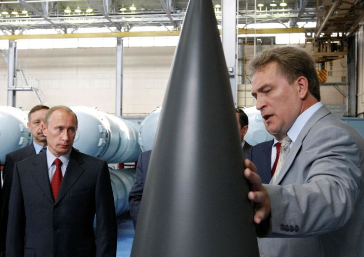 Russian Prime Minister Vladimir Putin (L) listens to the chief executive director of the Almaz-Antey Air Defence firm Vladislav Menschikov during a tour of its plant in Moscow July 28, 2008.  To match Special Report UKRAINE-CRISIS/RUSSIA-SANCTIONS  