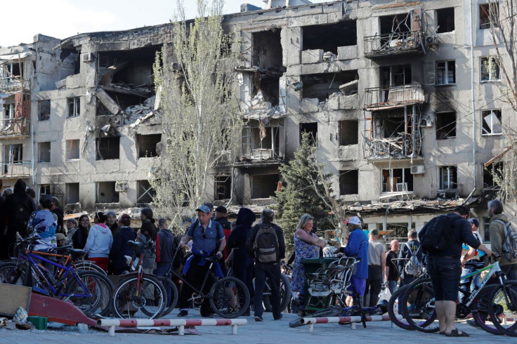 Local residents gather to receive humanitarian aid during Ukraine-Russia conflict in the southern port city of Mariupol, Ukraine April 28, 2022. 