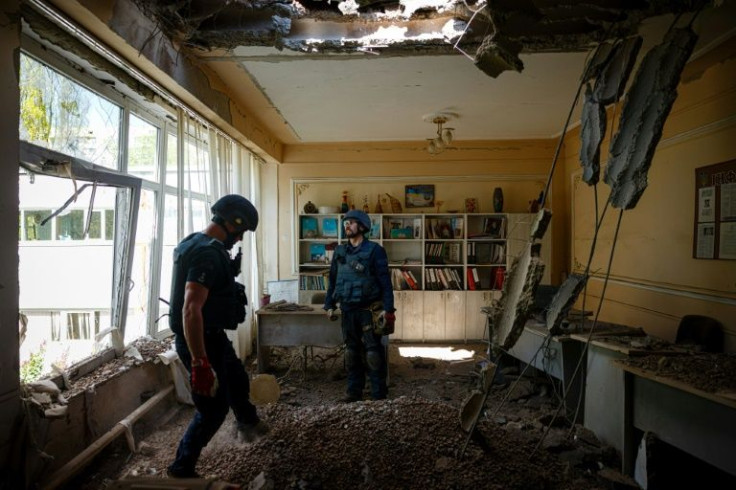One rocket punched a hole in the roof of a school in Kharkiv, blowing out the windows