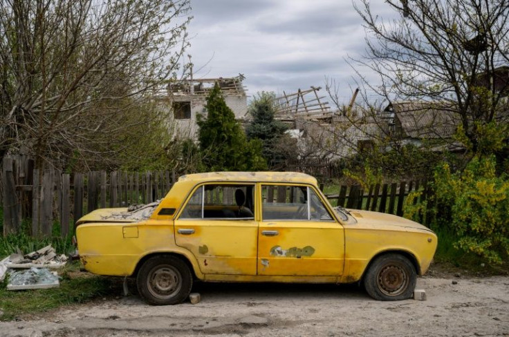 Across the road, the neighbours weren't so lucky, their house reduced to a pile of rubble, although their old yellow Lada was largely spared