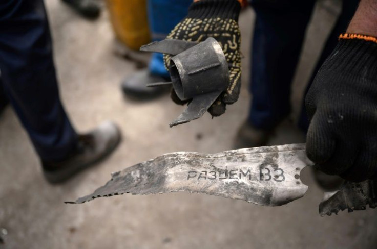 On one piece of shrapnel is a serial number but it is impossible to clearly say if the rocket is Russian or Ukrainian given that both sides use the same Soviet-era weaponsOne man hints that it may have been a stray projectile fired by Ukraine's anti-air
