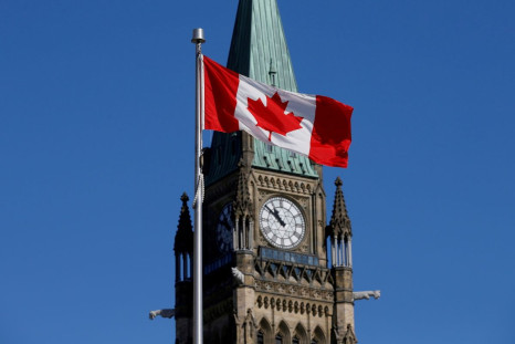 A Canadian flag flies in front of the Peace Tower on Parliament Hill in Ottawa, Ontario, Canada, March 22, 2017. 