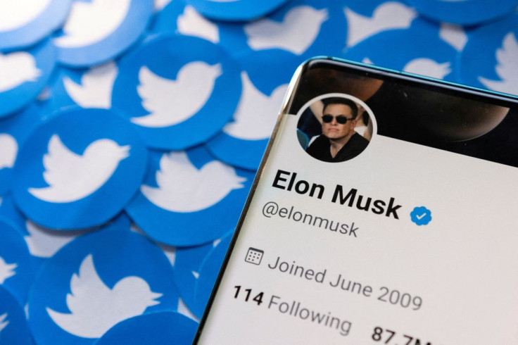 Elon Musk's Twitter profile is seen on a smartphone placed on printed Twitter logos in this picture illustration taken April 28, 2022. 