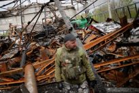 A Ukrainian army soldier looks at a destroyed shed, amid Russia's invasion of Ukraine, in the Zaporizhzhia region, Ukraine April 30, 2022.