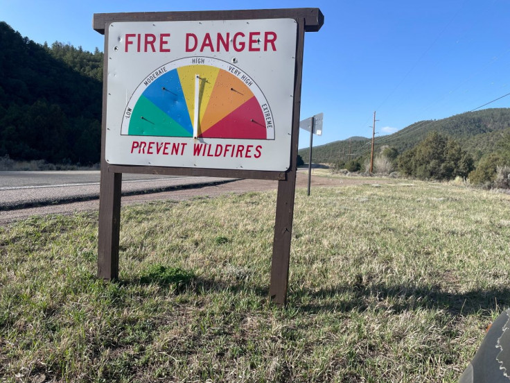 A sign indicates fire danger in mountains, where the Calf Canyon fire is burning, near Mora County, New Mexico, U.S., April 29, 2022.