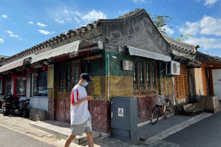 A person wearing a face mask walks in a hutong alley, after the government announced that COVID-19 test result within 48 hours is required before going to public places during the Labour Day holiday in the city, amid the coronavirus disease (COVID-19) out