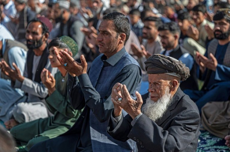 Muslims in Kabul offer Eid al-Fitr prayers, marking the end of the holy fasting month of Ramadan outside a mosque on Sunday