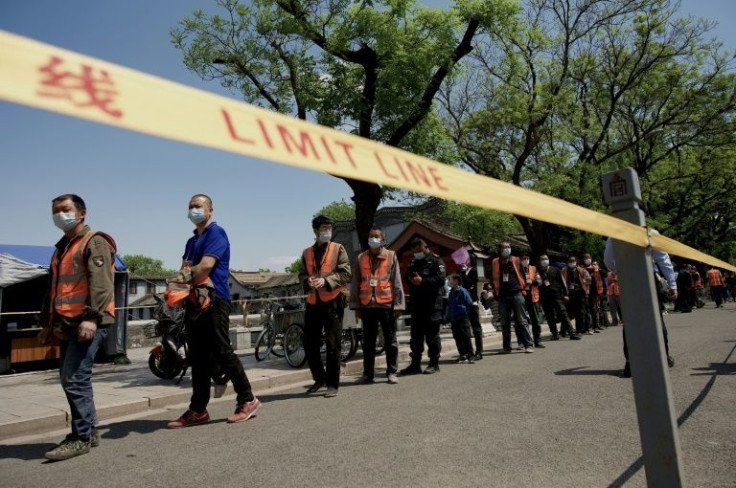 People queue for a swab test for the Covid-19 coronavirus near the entrance of the Forbidden City in Beijing