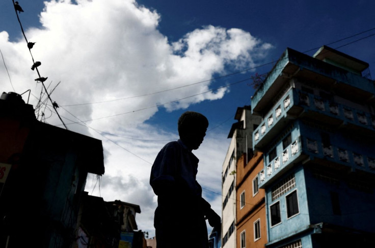 FILE PHOTO - A worker stands in front of a closed essential food store during a nationwide strike demanding the resignation of President Gotabaya Rajapaksa and his cabinet, amid the country's economic crisis, in Colombo, Sri Lanka, April 28, 2022.