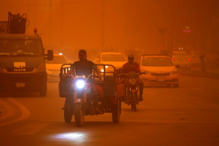 Vehicles drive along a road during a severe dust storm in Iraq's capital Baghdad