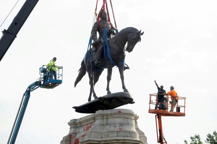 A statue of Robert E. Lee, leader of the armed forces of the slave-holding Confederacy, being removed from its pedestal in September 2021 in Richmond, Virginia