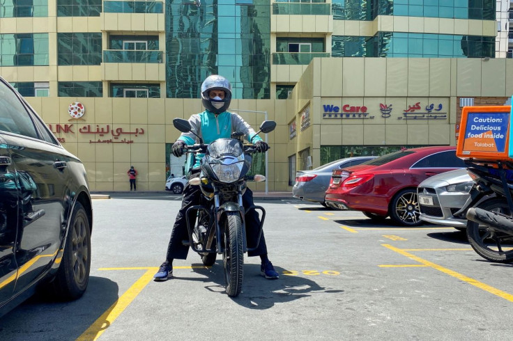 A food delivery worker rides a motorbike to deliver meal orders, following the outbreak of the coronavirus disease (COVID-19), in Dubai, United Arab Emirates, May 14, 2020. Picture taken May 14, 2020.