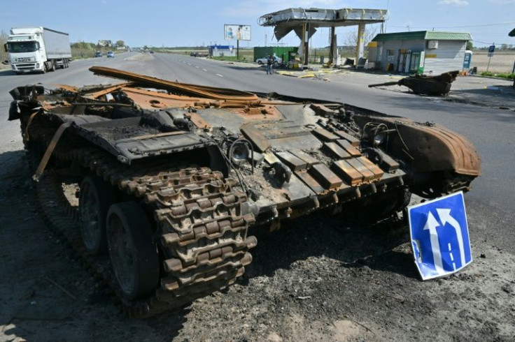 The remains of a Russian tank lying next to a destroyed Ukrainian petrol station highlight the multiple sides of the war's toll