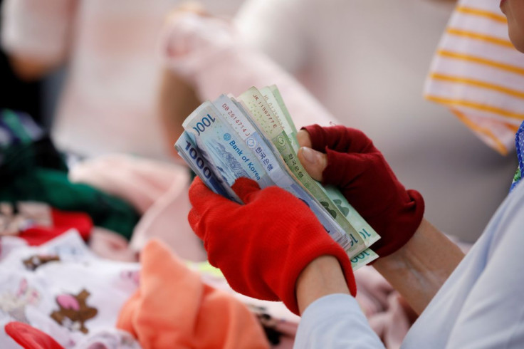 A street vendor counts his money at the Namdaemun Market in Seoul, South Korea, May 30, 2017.