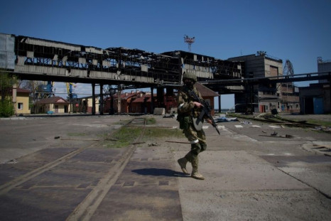 A Russian serviceman patrols in the port of Mariupol amid the ongoing Russian military action in Ukraine