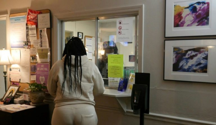 A woman stands at the check-in window of a Louisiana abortion clinic on April 19, 2022