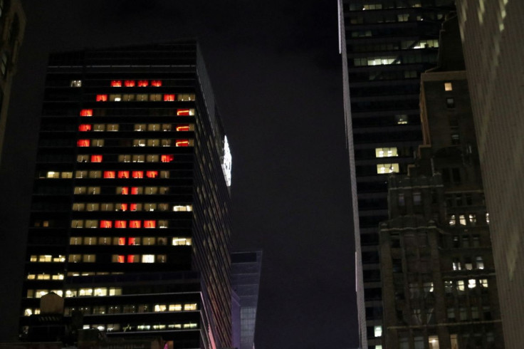 The female gender symbol is seen displayed on the Ernst and Young Building on International Women's Day in Times Square in New York City, New York, U.S., March 8, 2018.