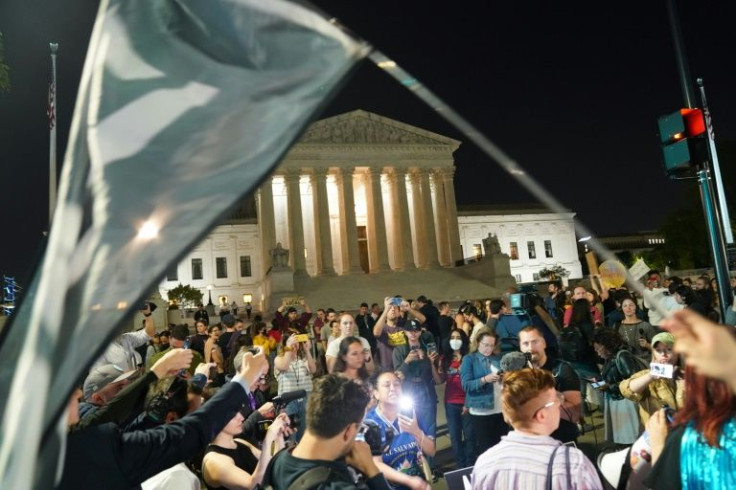 Pro-choice and anti-abortion activists gather outside the Supreme Court in Washington following the leak