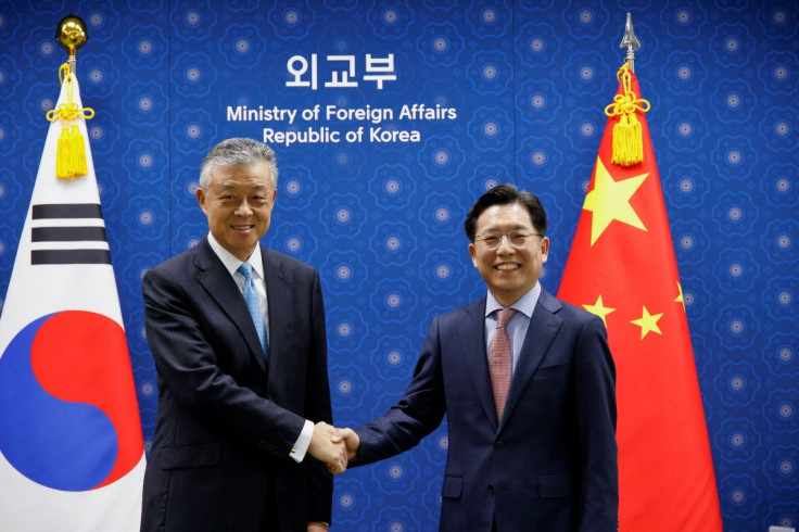 Chinese Special Representative on Korean Peninsula Affairs Liu Xiaoming shakes hands with South Korea's Special Representative for Korean Peninsula Peace and Security Affairs Noh Kyu-duk during a meeting at the Foreign Ministry in Seoul, South Korea, May 