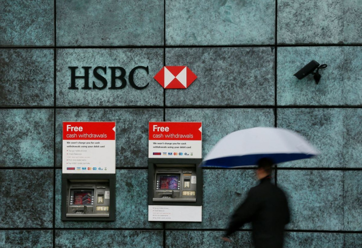A man walks past a HSBC bank branch in the City of London, Britain November 12, 2014.