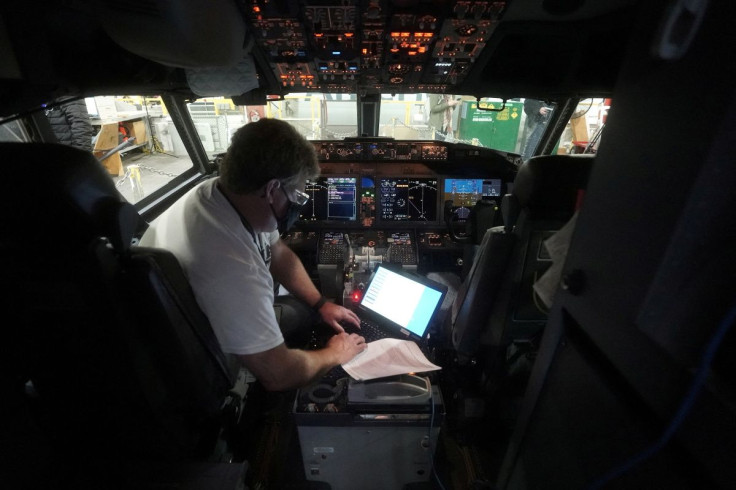 A worker loads new software into the Boeing 737 Max airplane in a maintenance hangar in Tulsa, Oklahoma, U.S., December 2, 2020.