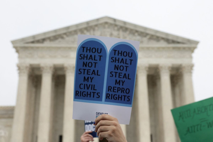 A demonstrator holds a sign during a protest outside the U.S. Supreme Court after the leak of a draft majority opinion written by Justice Samuel Alito preparing for a majority of the court to overturn the landmark Roe v. Wade abortion rights decision late