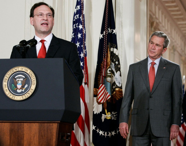 U.S. Supreme Court Justice Samuel Alito (L) delivers remarks after being sworn in as U.S. President George W. Bush looks on during a ceremony in the East Room at the White House in Washington, February 1, 2006. 
