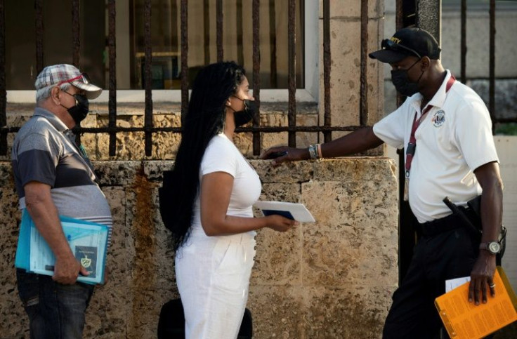 A small number of Cubans waited in line for the first visas issued in more than four years at the US embassy in Havana