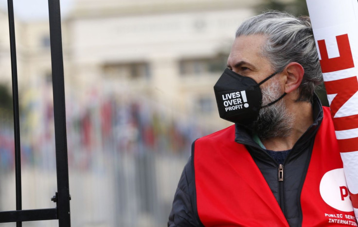 A man attends a demonstration for an intellectual property rights waiver for COVID-19 vaccines and supplies aside from meeting of the Council for Trade-Related Aspects of Intellectual Property Rights (TRIPS) of the World Trade Organization (WTO) headquart
