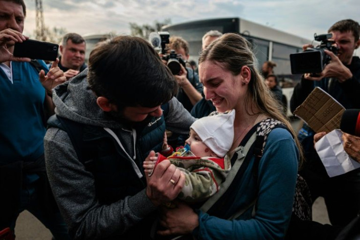 A man welcomes Anna Zaitseva and her six-month-old son Svyatoslav