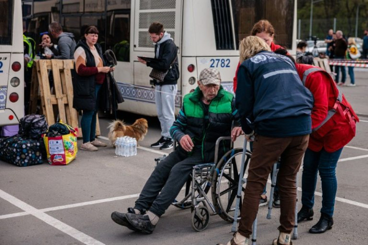 Evacuees from Mariupol's Azovstal plant arrive on buses at a registration and processing area