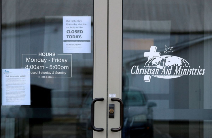 Signs on the door of the Christian Aid Ministries give updates on the Haiti kidnapping and show the the offices are closed in Millersburg, Ohio, U.S. October 21, 2021.  