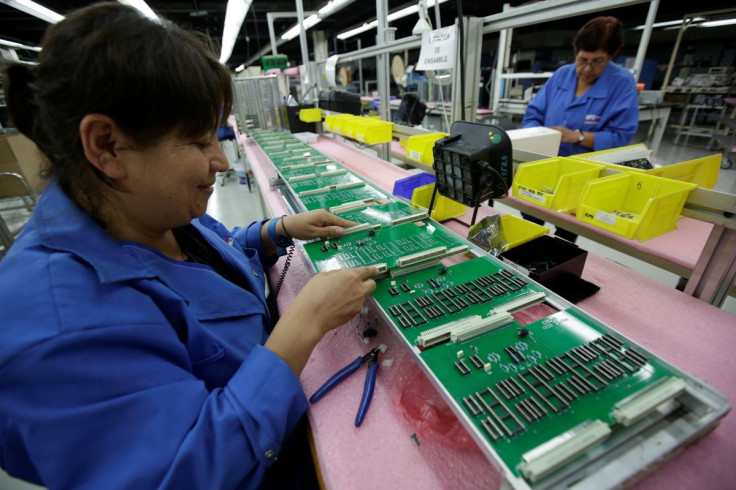 Employees work on printed circuit boards at the assembly line of a factory that exports to the U.S., in Ciudad Juarez, Mexico, July 13, 2017. 