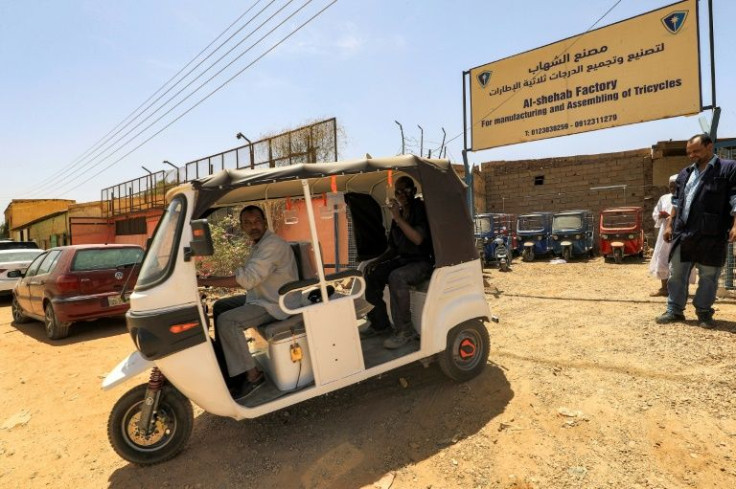 Sudanse workers test a new electric tuk-tuk