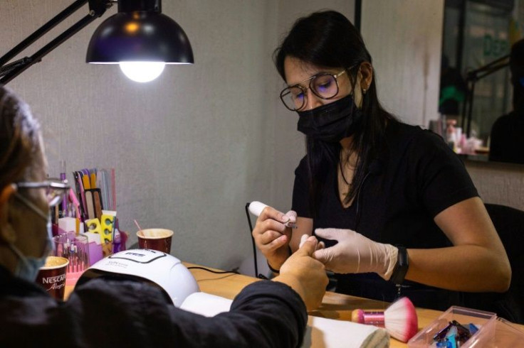 Manicurist Yara Gonzalez returned home from Peru to her native Venezuela and found an improved economic environment