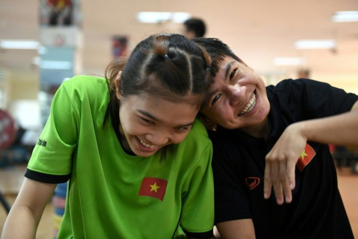 Nguyen Thi Thu Nhi, right, Vietnam's first boxing world champion, enjoys some downtime during training in Ho Chi Minh City with a national teammate