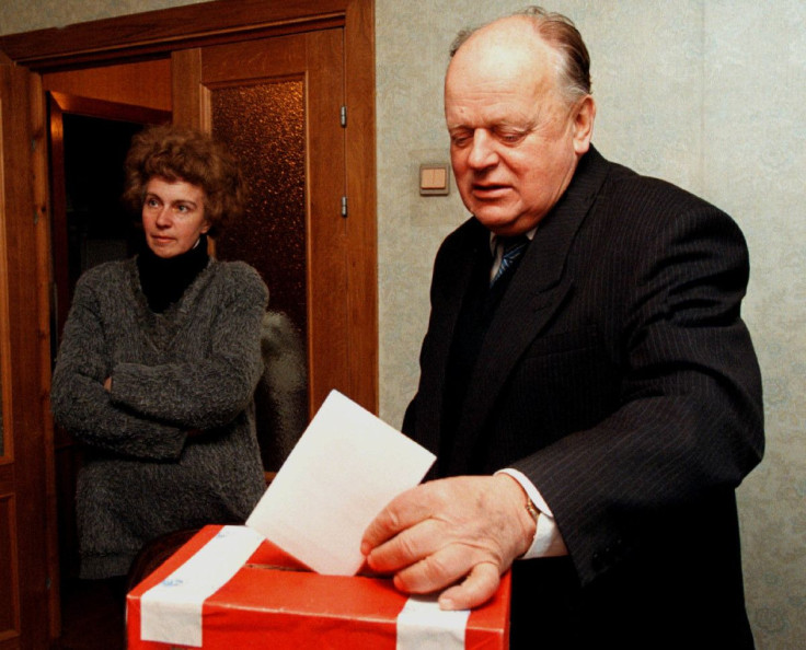 Former speaker of Belarussian parliament Stanislav Shushkevich drops his voting ballot in a box as his wife Irina stands behind him in their apartment in Minsk, Belarus, May 13, 1999. Reuters Photographer/ File Photo