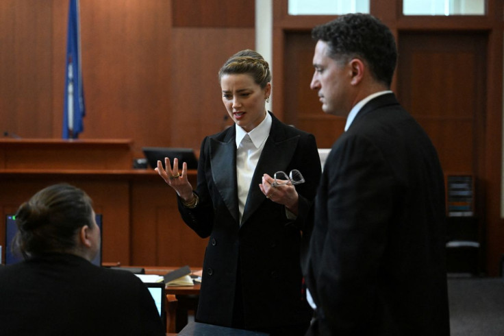 Actor Amber Heard speaks to her lawyer in the courtroom at Fairfax County Circuit Court during a defamation case against her by actor Johnny Depp, her ex-husband, in Fairfax, Virginia, U.S., May 3, 2022. Jim Watson/Pool via REUTERS